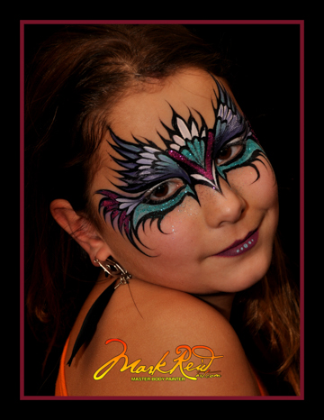 youg girl in a painted on face mask that is very colorful